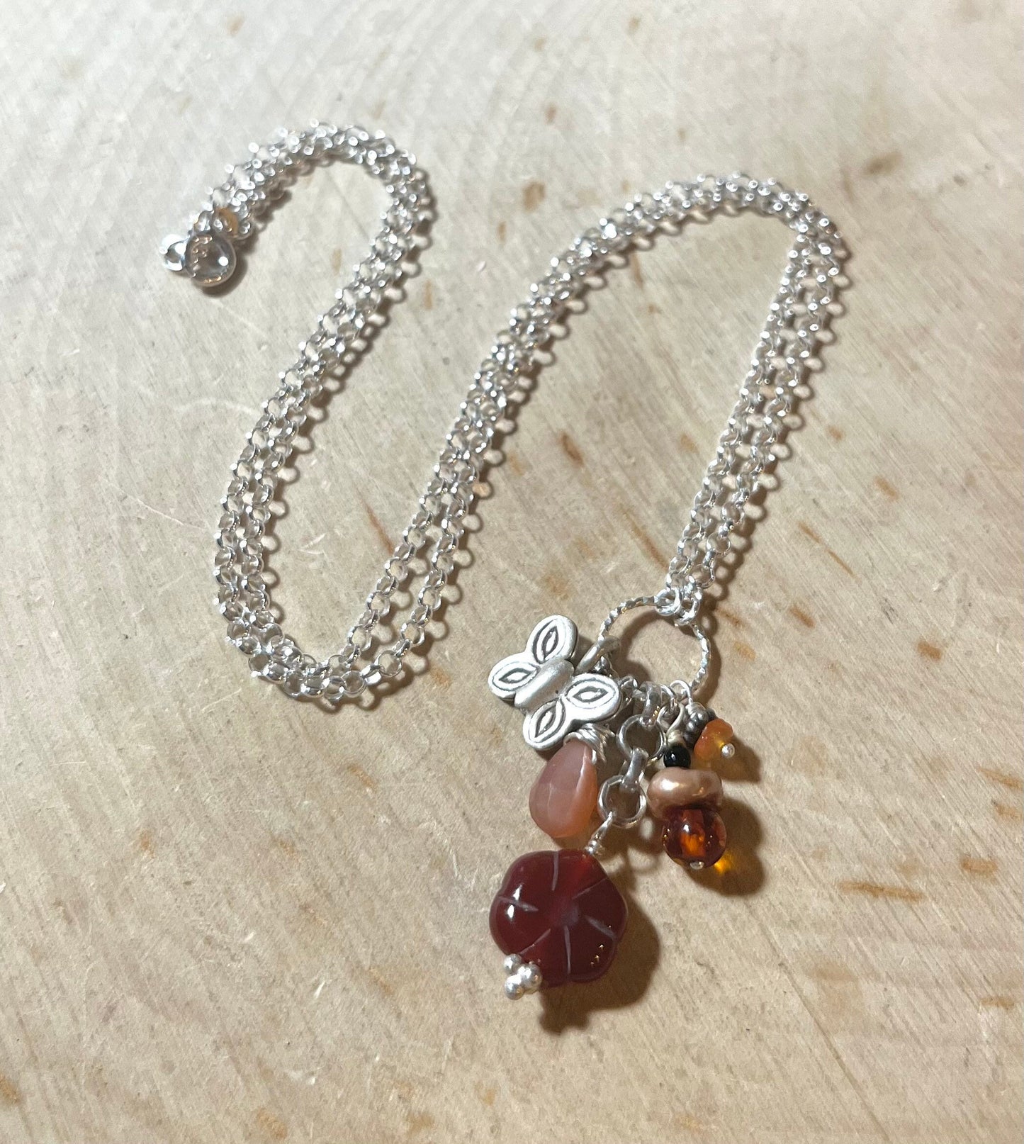 Butterfly Necklace with carnelian flower, peach moonstone, amber, pearls