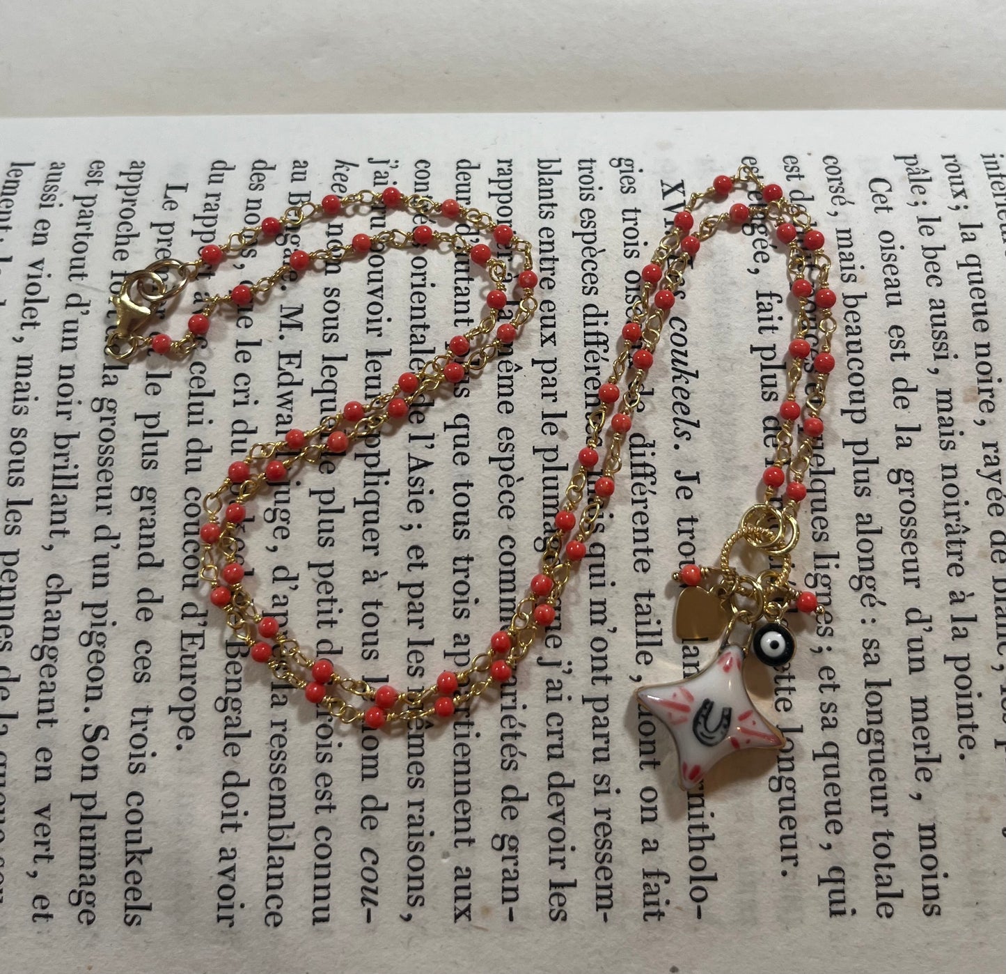 Horseshoe Star necklace with Sha Parle pottery charm, coral, evil eye charm and 14k gold-filled